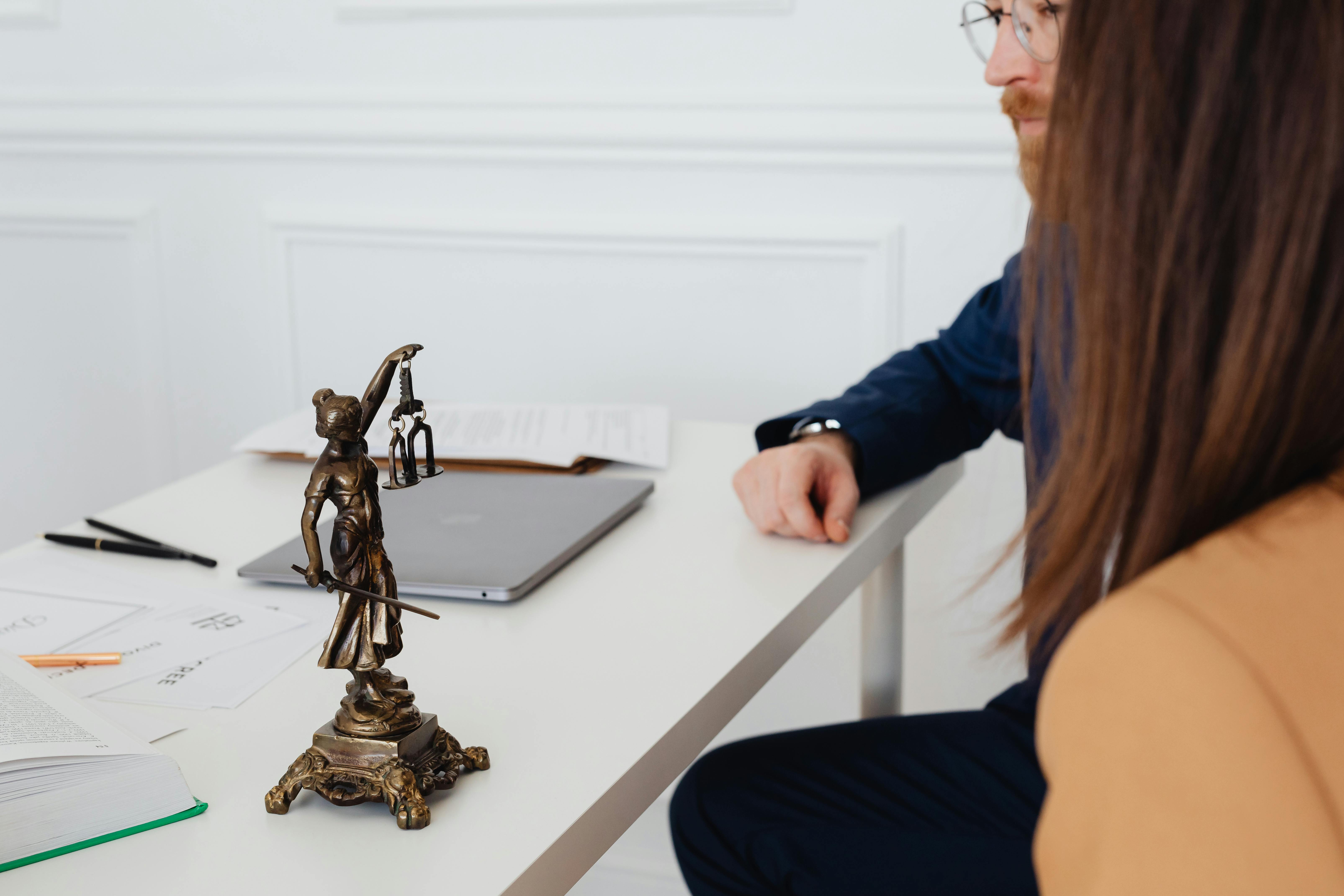 Couple sitting in a lawyer's office.