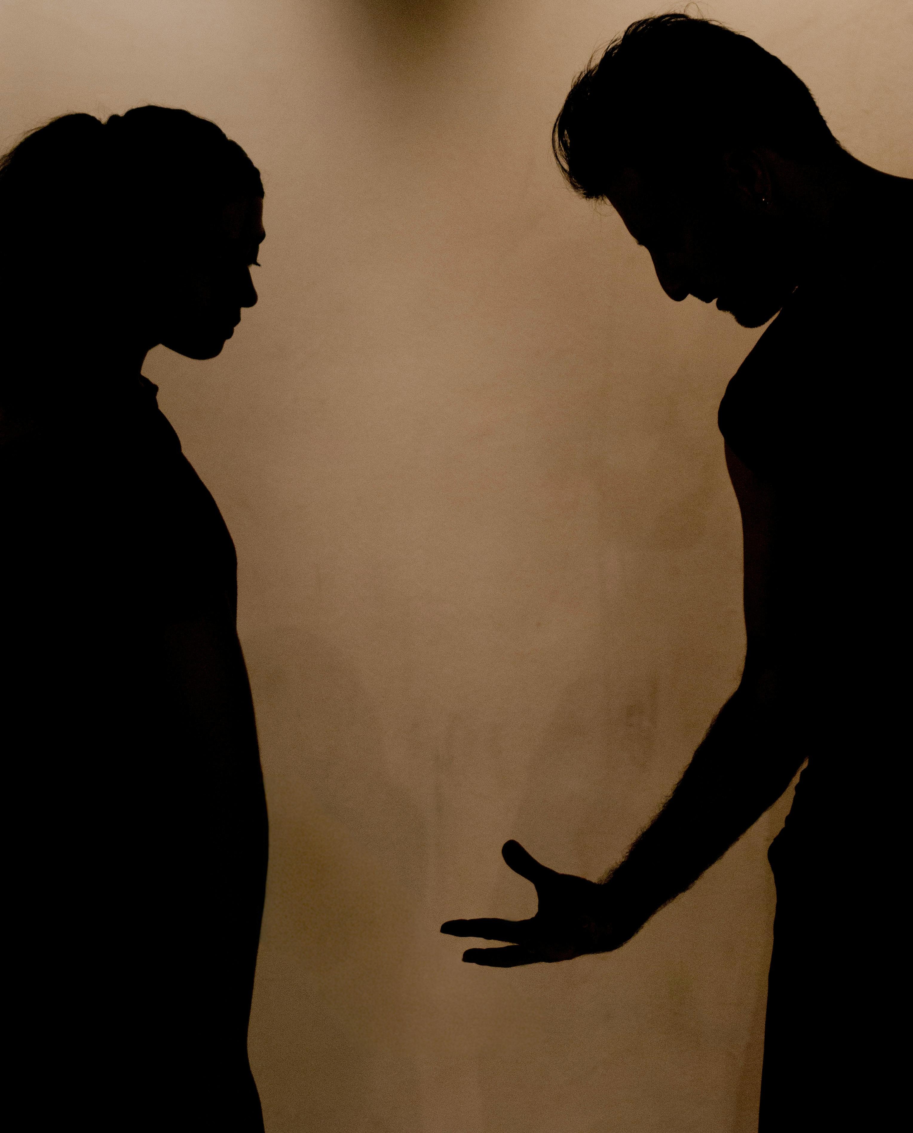 Silhouette of a couple arguing